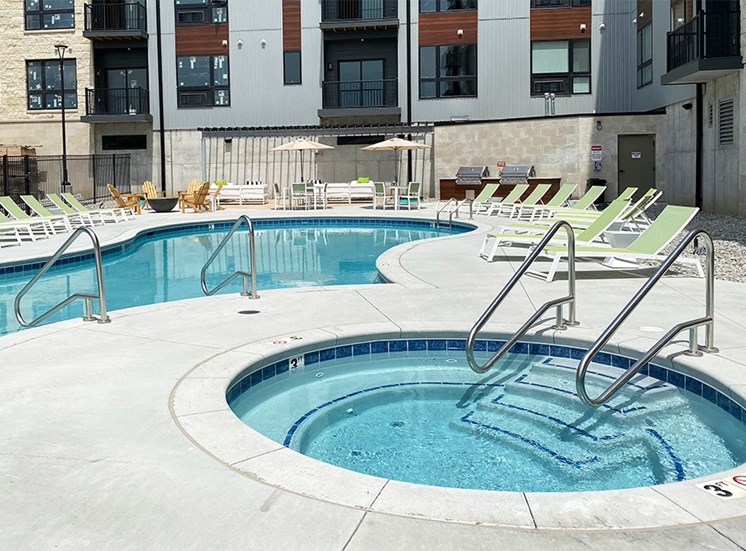 Circular spa hot tub near then outdoor resort style pool at Haven at Uptown.