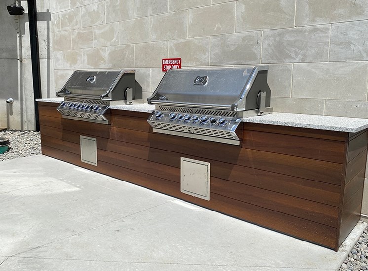 Two stainless steel grills built into in an outdoor kitchen at Haven at Uptown.