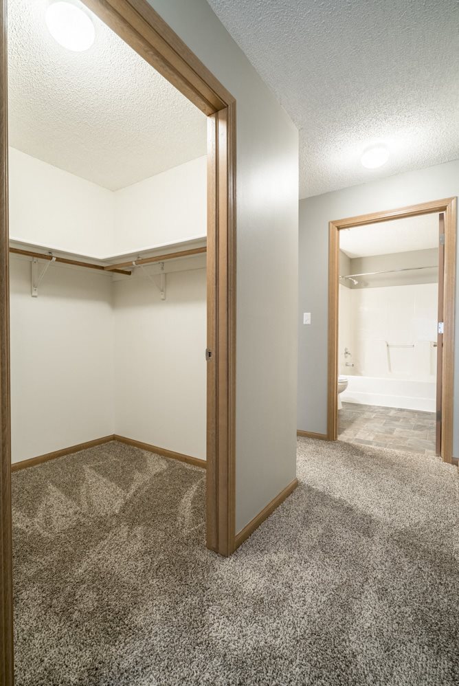 View into the doorways of a walk in closet and bathroom at Highland View