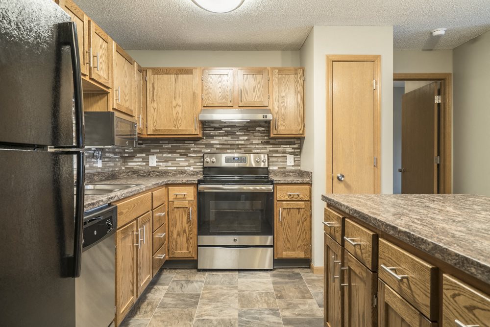 Interiors-Renovated kitchen with tile backsplash and new appliances at Highland View