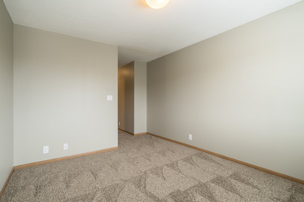 Empty bedroom with carpet and open space at Highland View
