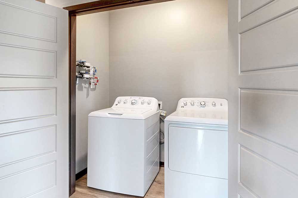 North Pointe Villas side by side washer and dryer in an apartment laundry room