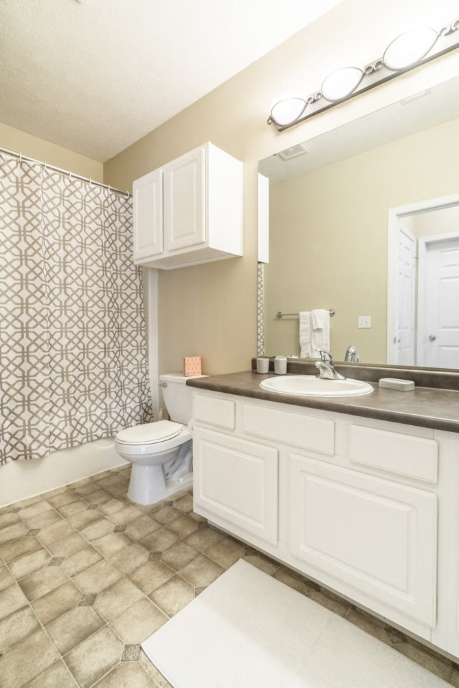 Interiors-Bathroom with white cabinetry and bathtub at Ridge Pointe Villas