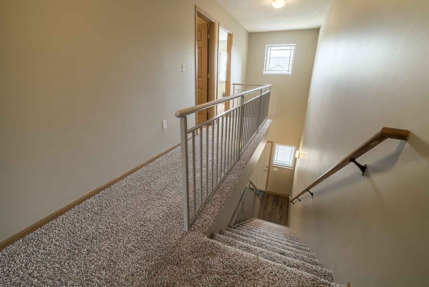 Stairwell to upstairs in a two-bedroom townhome at Southwind Villas in southwest Omaha in La Vista, NE, 68128