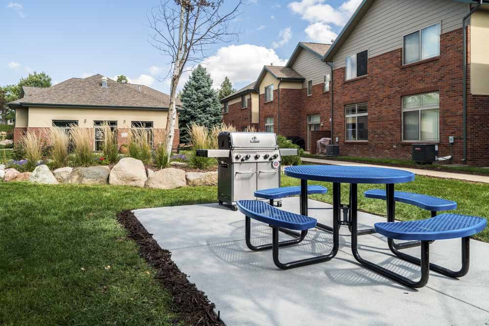 Outdoor grill with picnic table in the courtyard  at Southwind Villas in southwest Omaha in La Vista, NE, 68128