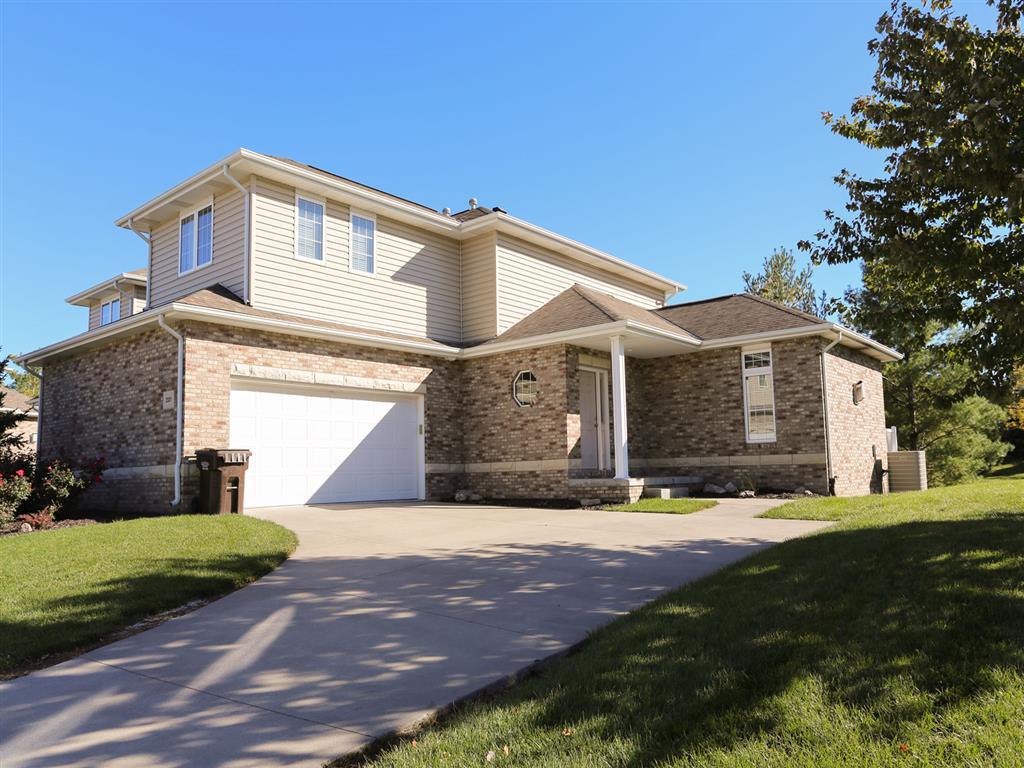 two-story duplex with driveway and 2 car garage