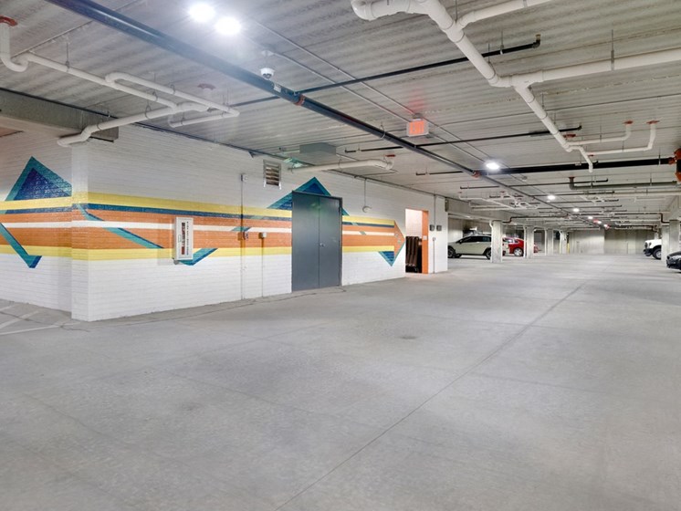 Underground parking garage with colorful mural painted on two interior walls