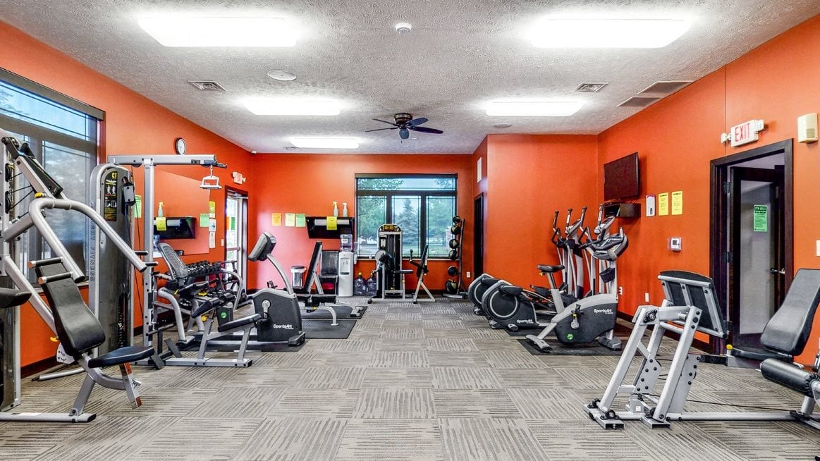 Expansive fitness room with modern equipment at The Villas at Wilderness Ridge luxury apartments in southwest Lincoln NE 68512
