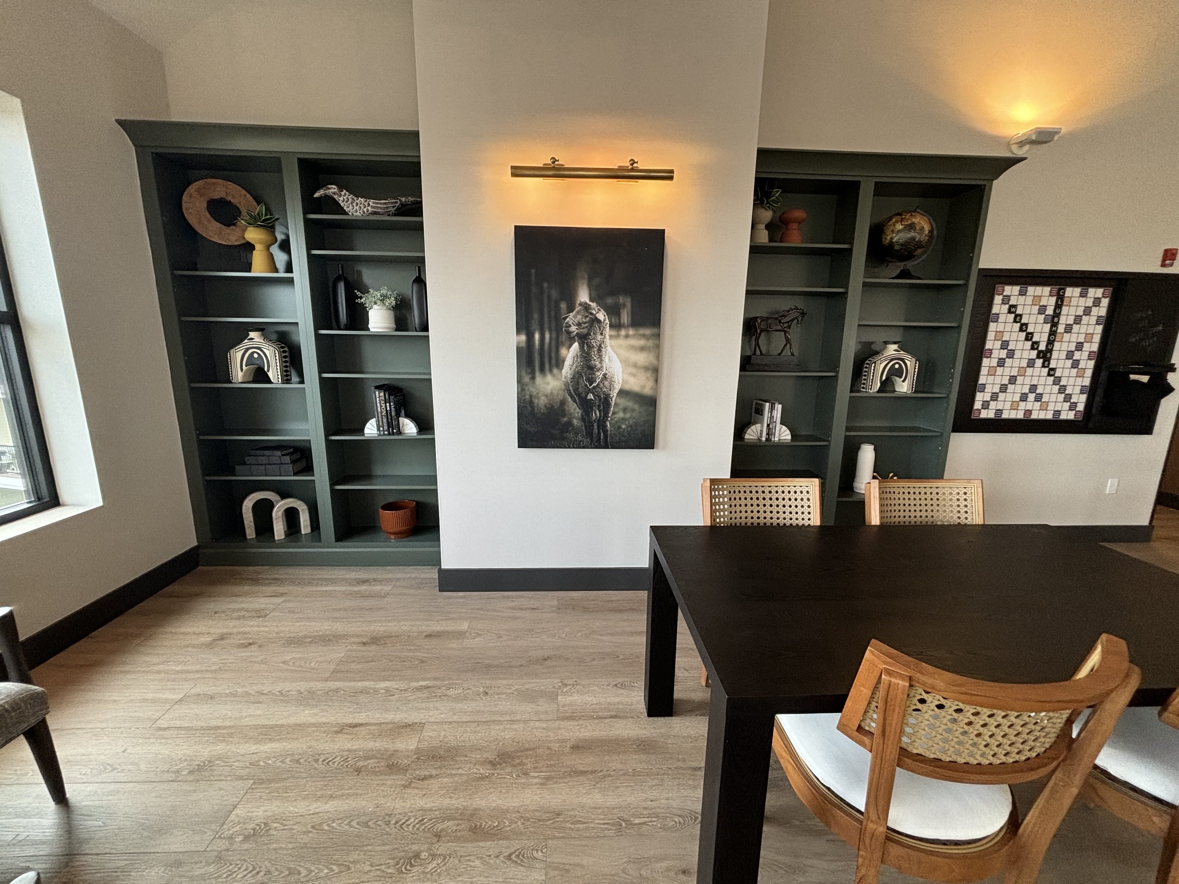 a dining room with a table and chairs and a bookshelf