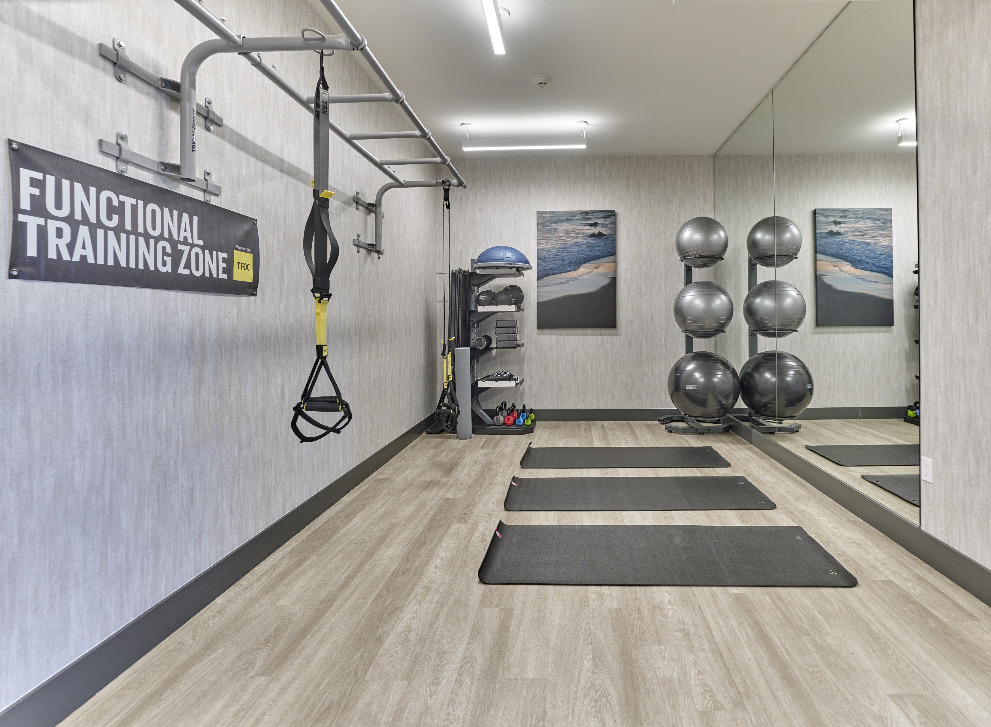 a functional training zone with weights and yoga mats on the floor