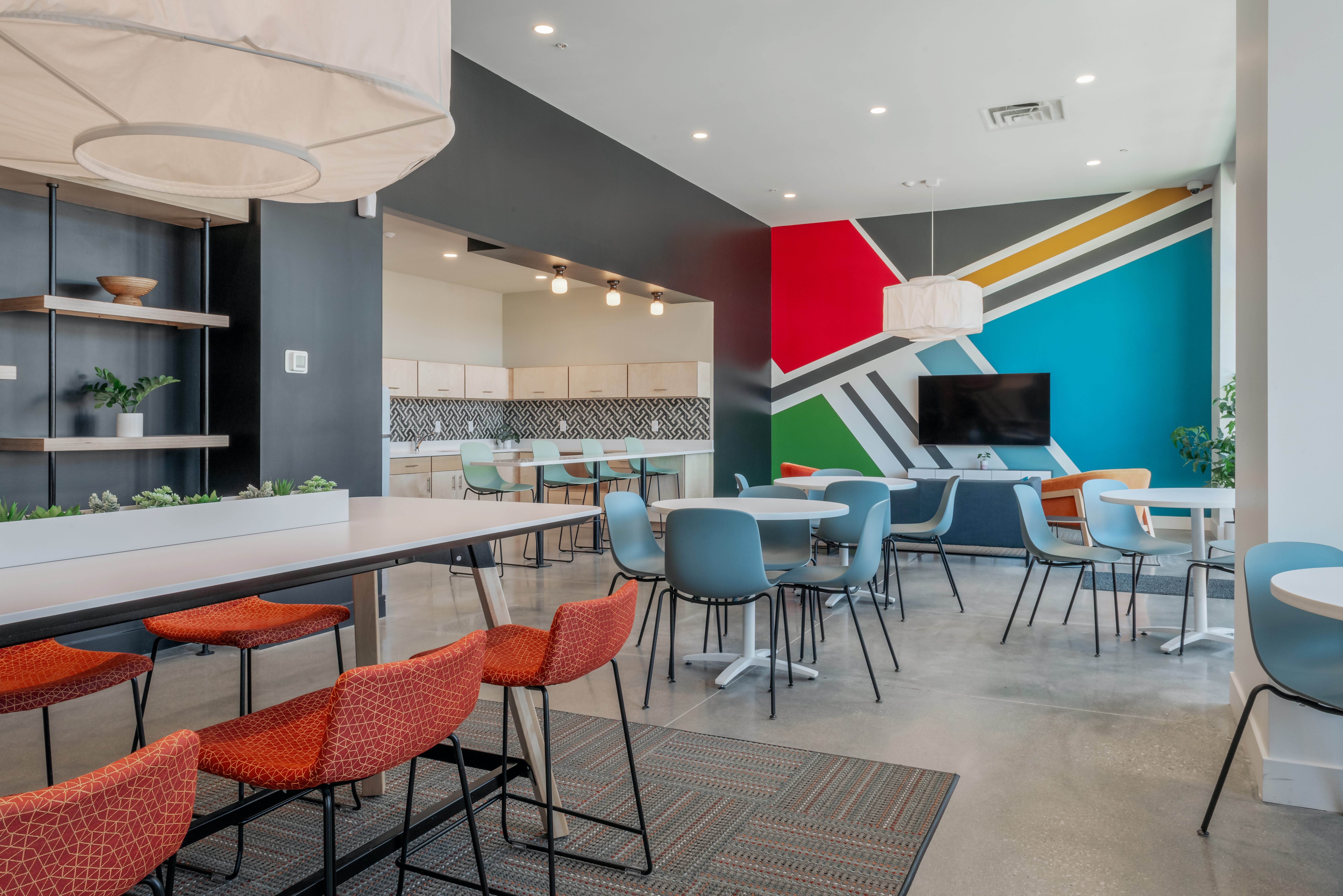 A modern dining area with a long table and chairs.