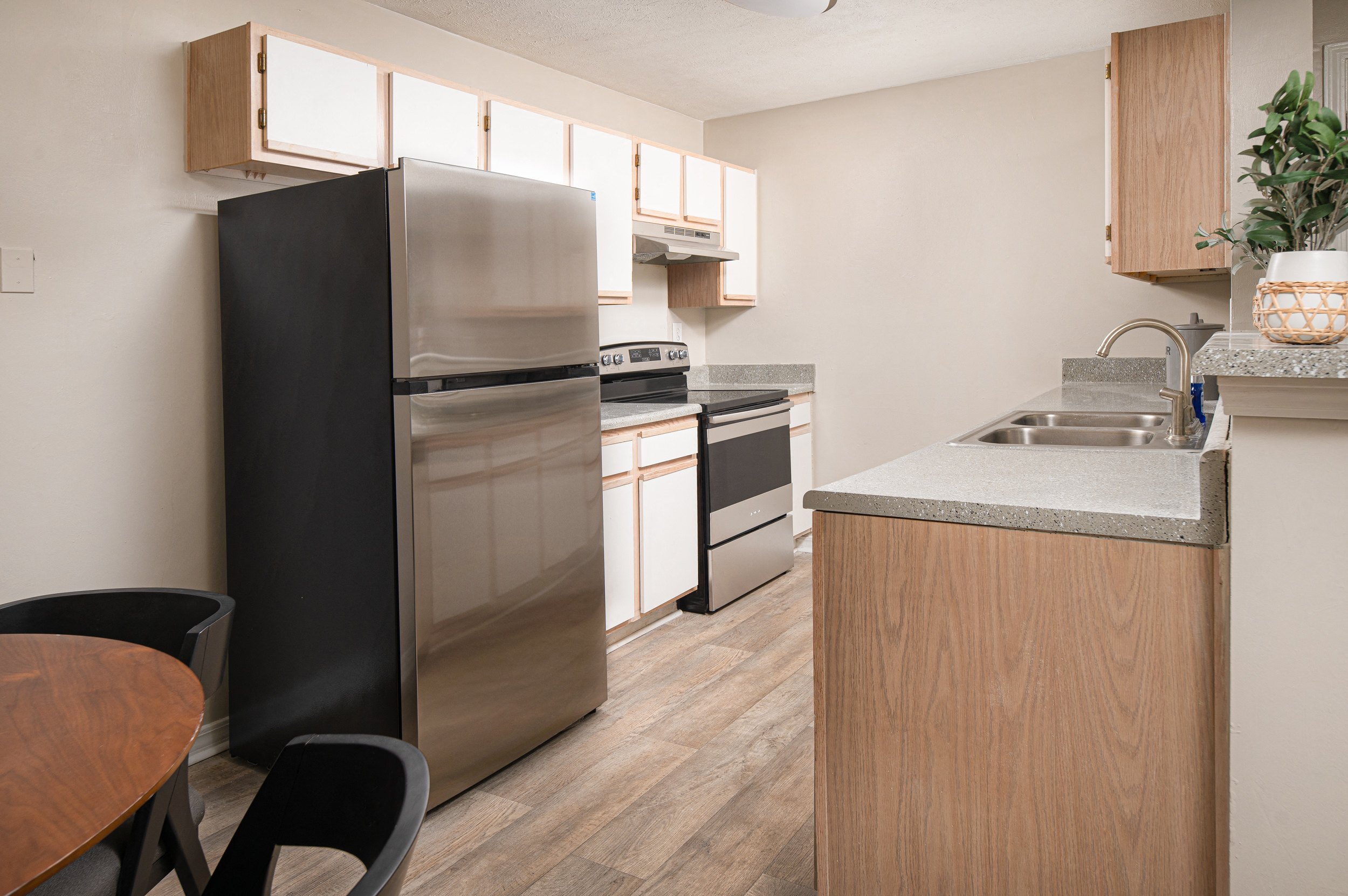 a kitchen with white cabinets and stainless steel appliances