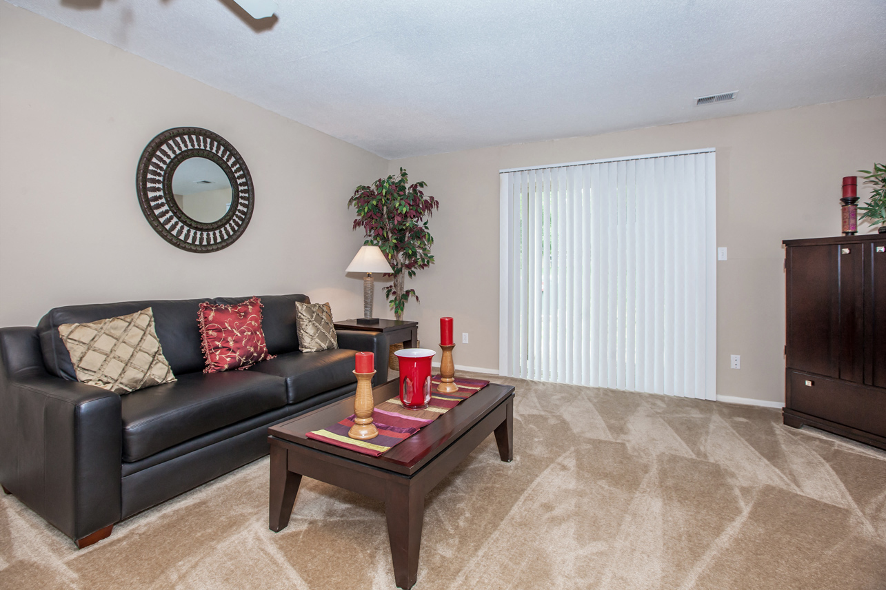 Living room with couch at Preston Court Apartments, Kansas