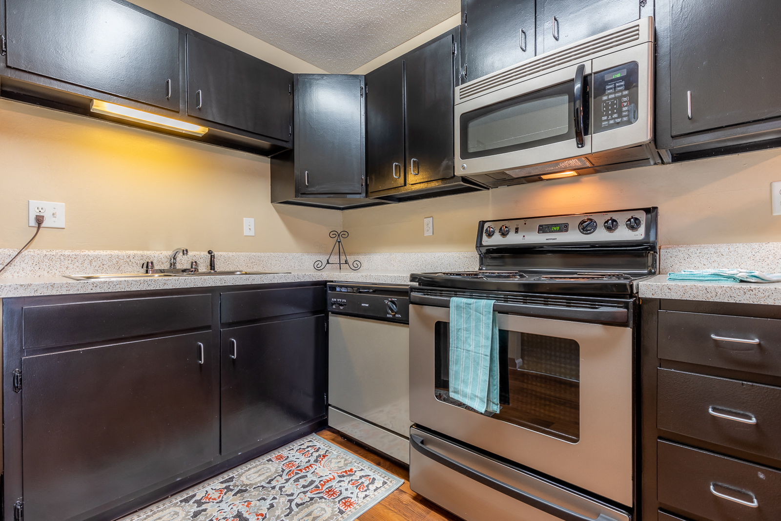 Kitchen with appliances and cabinets1at Preston Court Apartments, Overland Park, KS, 66212