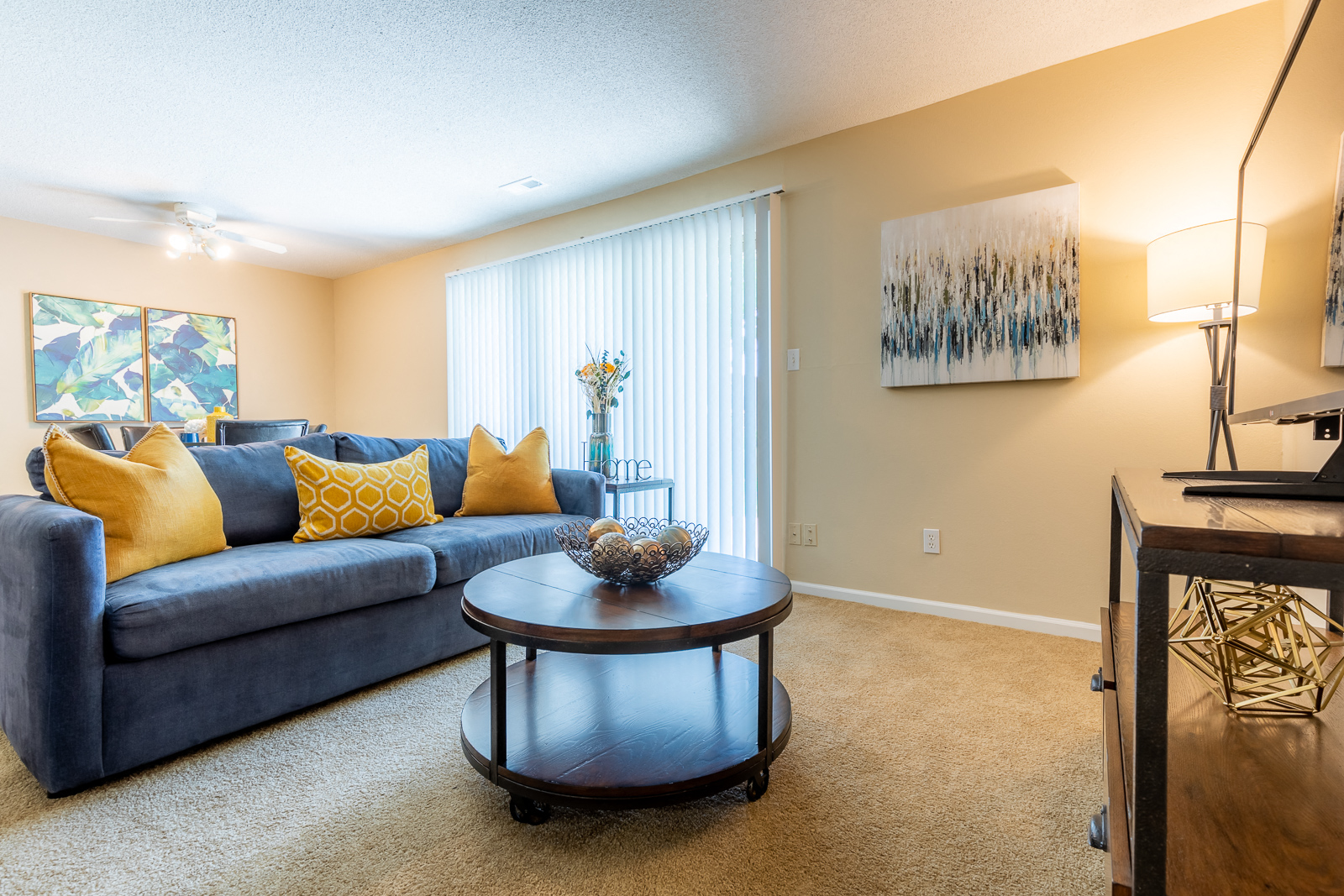 Living room with blue couch1 at Preston Court Apartments, Kansas, 66212