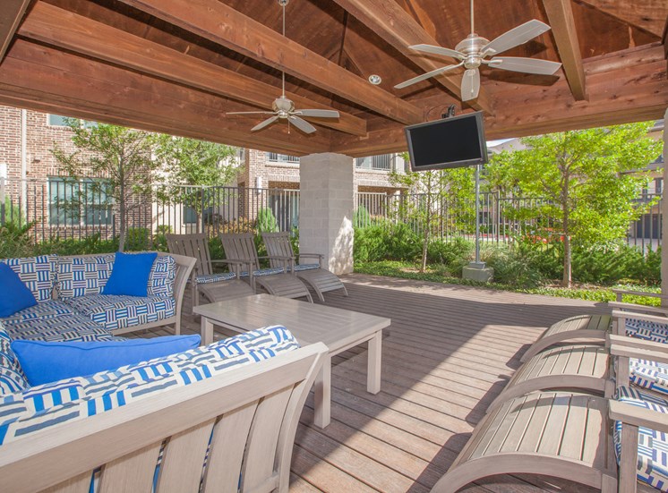 outdoor living area with chairs and tv