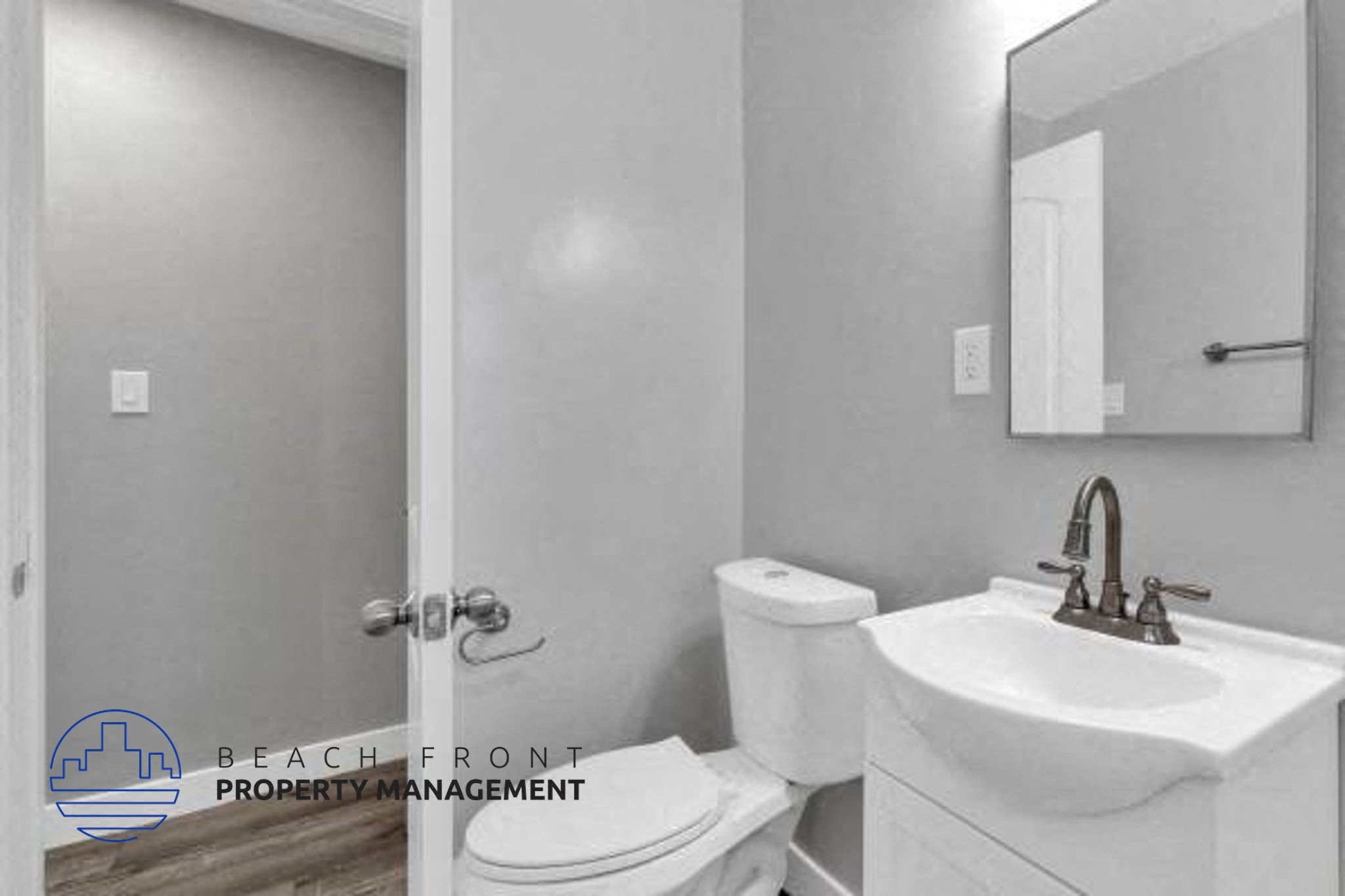 a bathroom with a toilet and a sink and a mirror