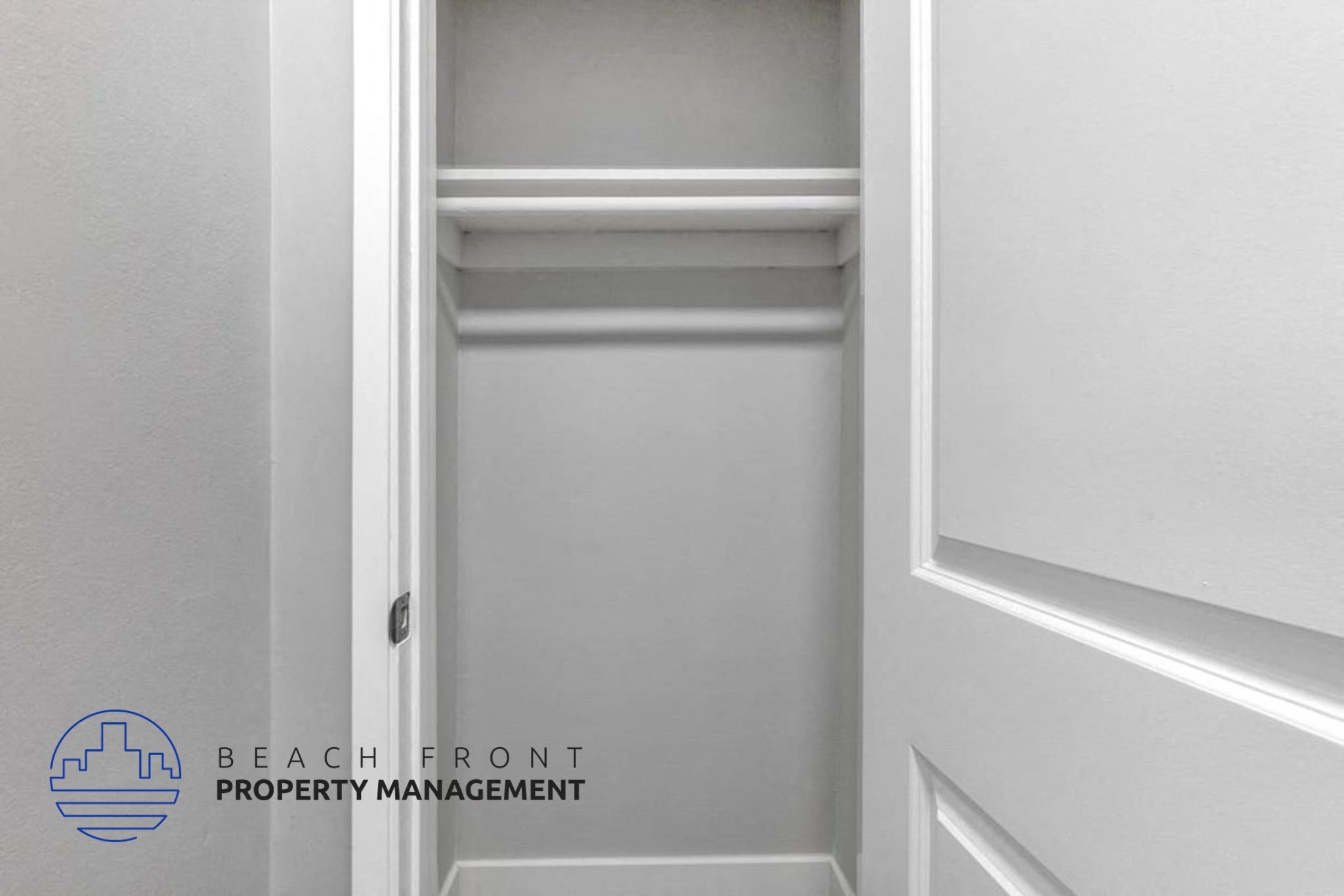 a white closet with a white wall and a white door