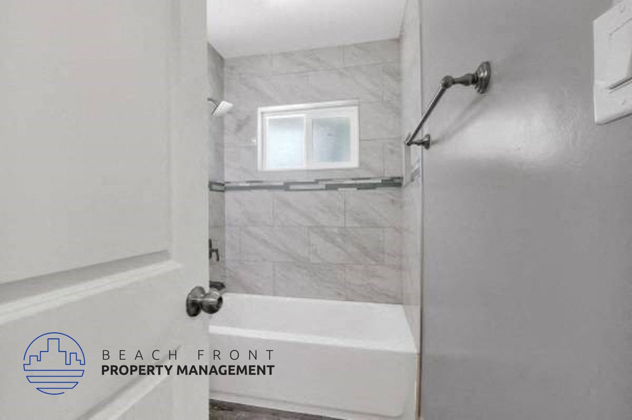 a white bathroom with a tub and a window in it