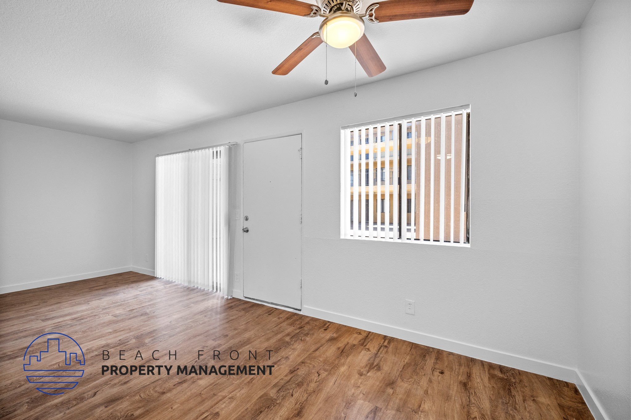 A room with a ceiling fan and a window with blinds.,A room with a ceiling fan and a window with blinds.