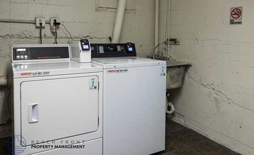 A piece of industrial equipment sits on a table in a room with a no smoking sign on the wall.