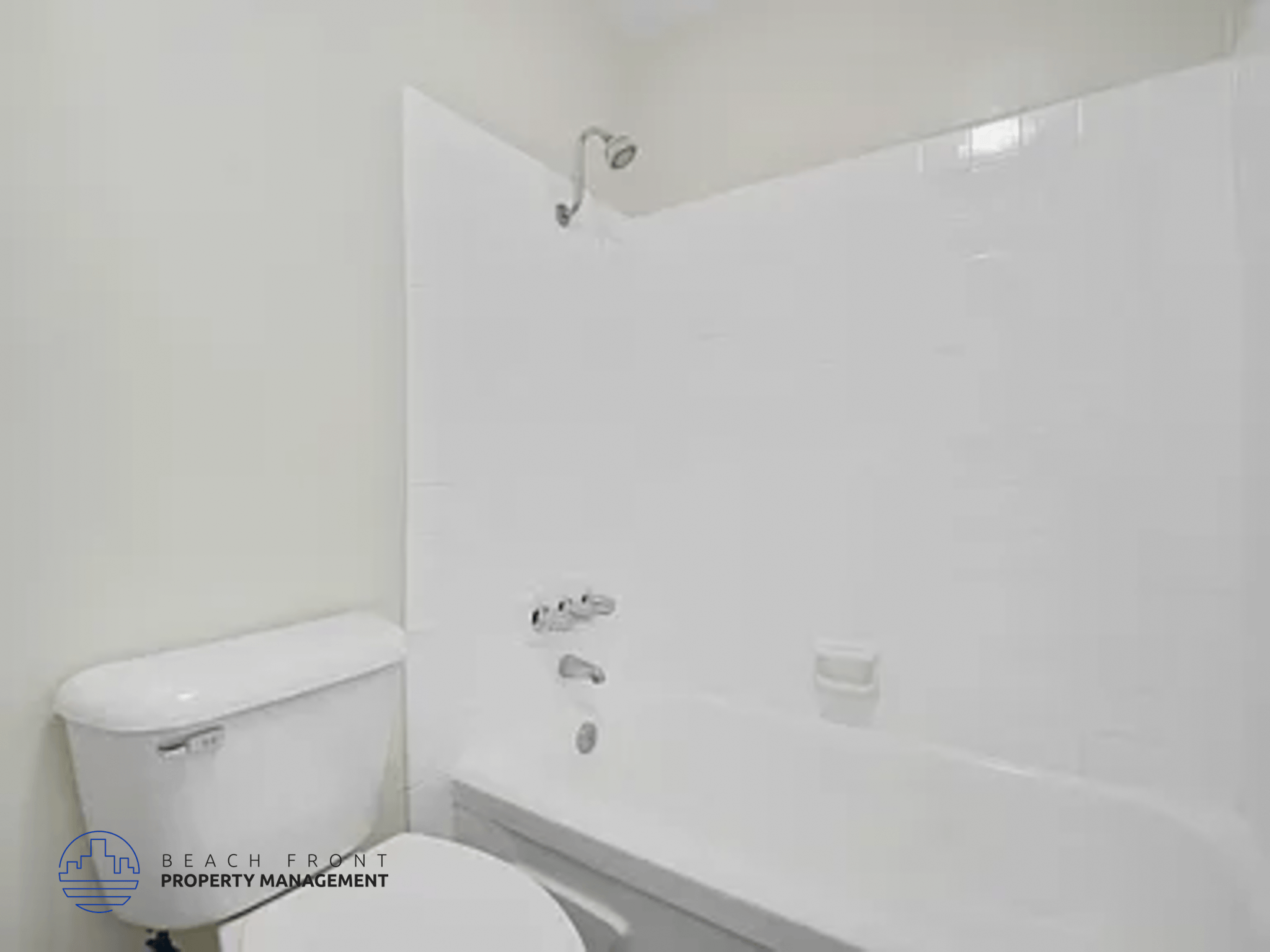 A white toilet and sink in a bathroom.