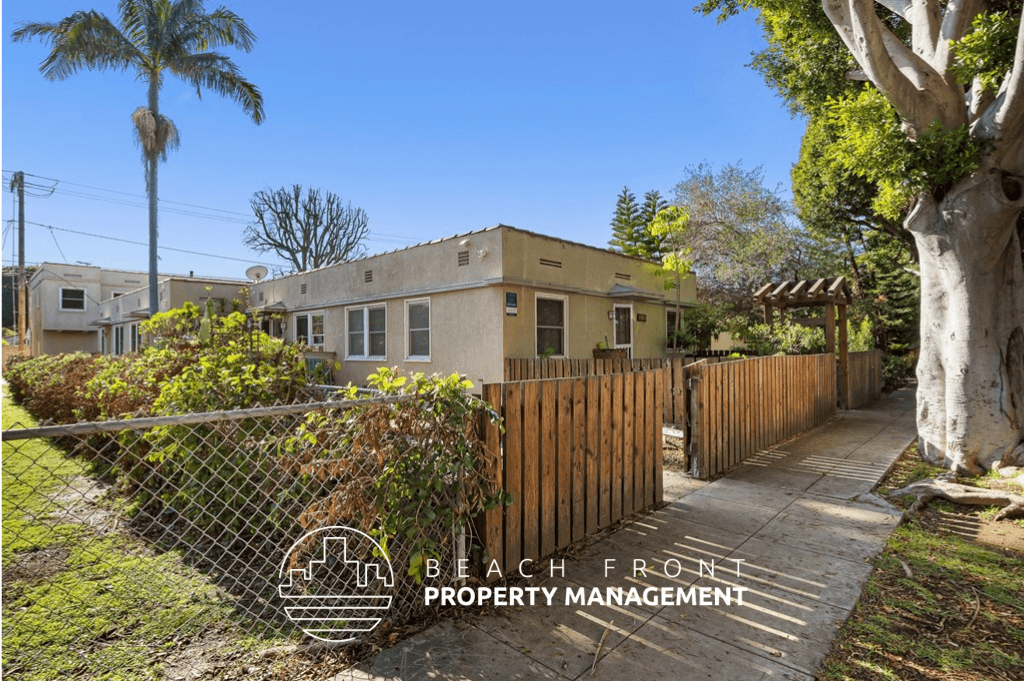 a house with a fence and a sidewalk in front of it