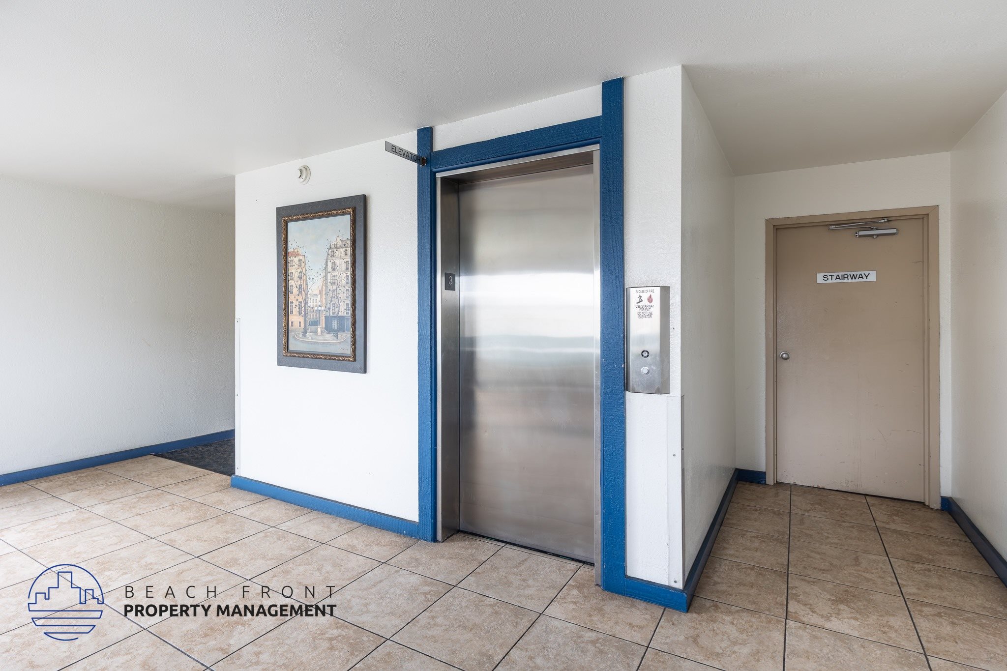 A hallway with a blue door and a sign that says