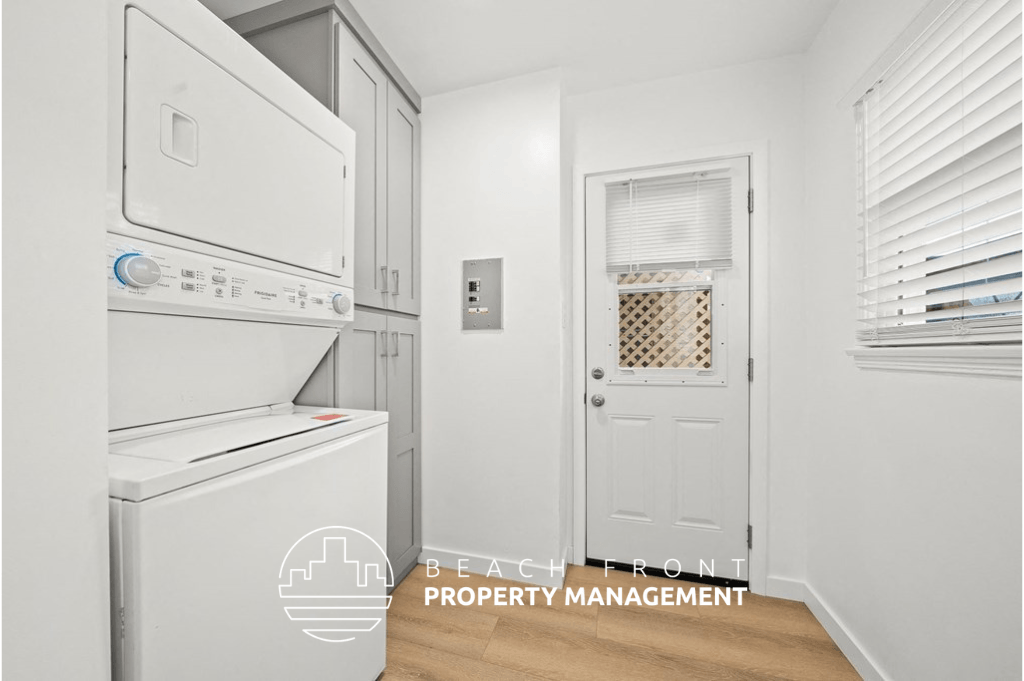 a white laundry room with white appliances and a white door