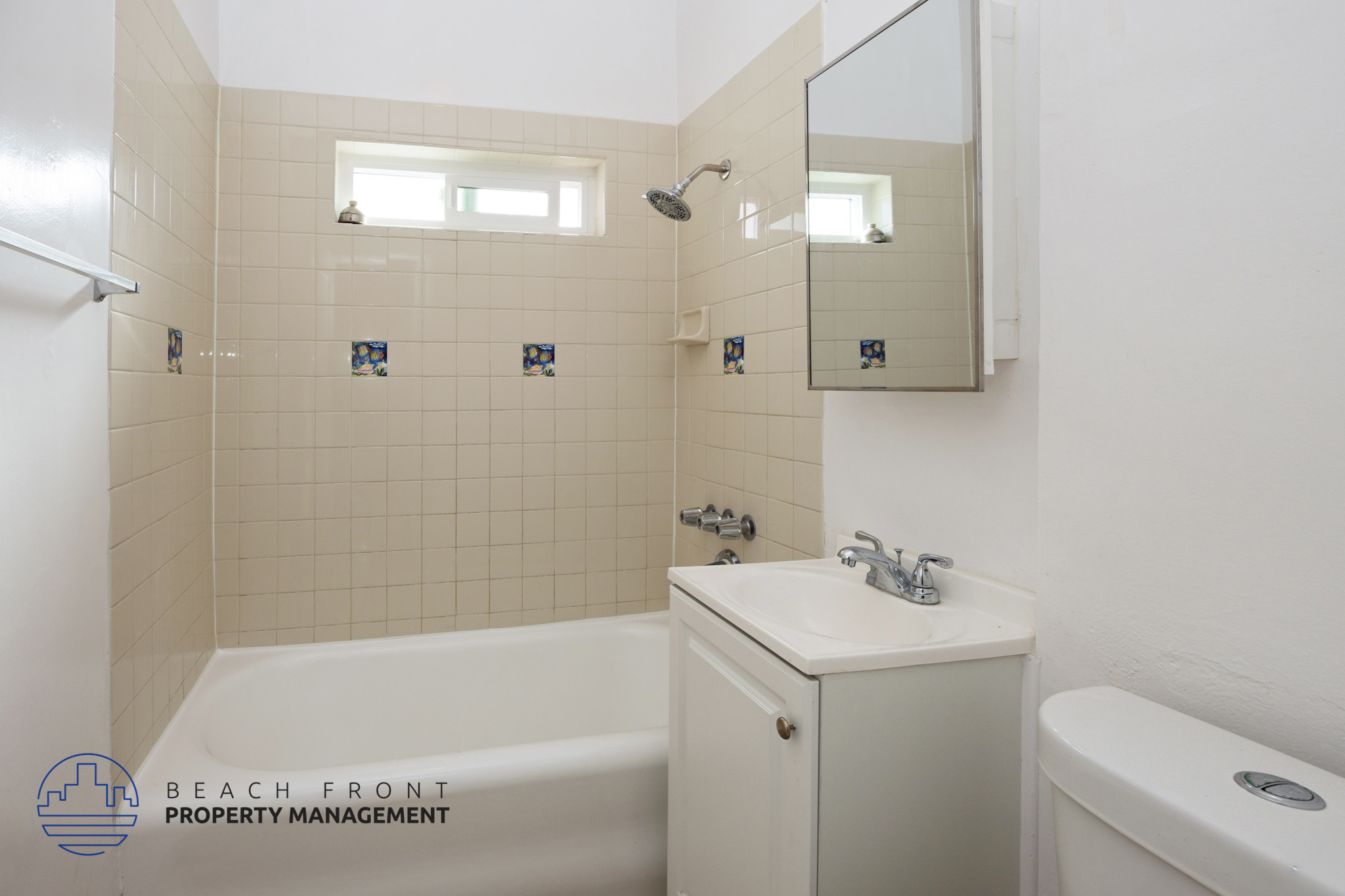 A bathroom with a white tub, sink, and toilet.
