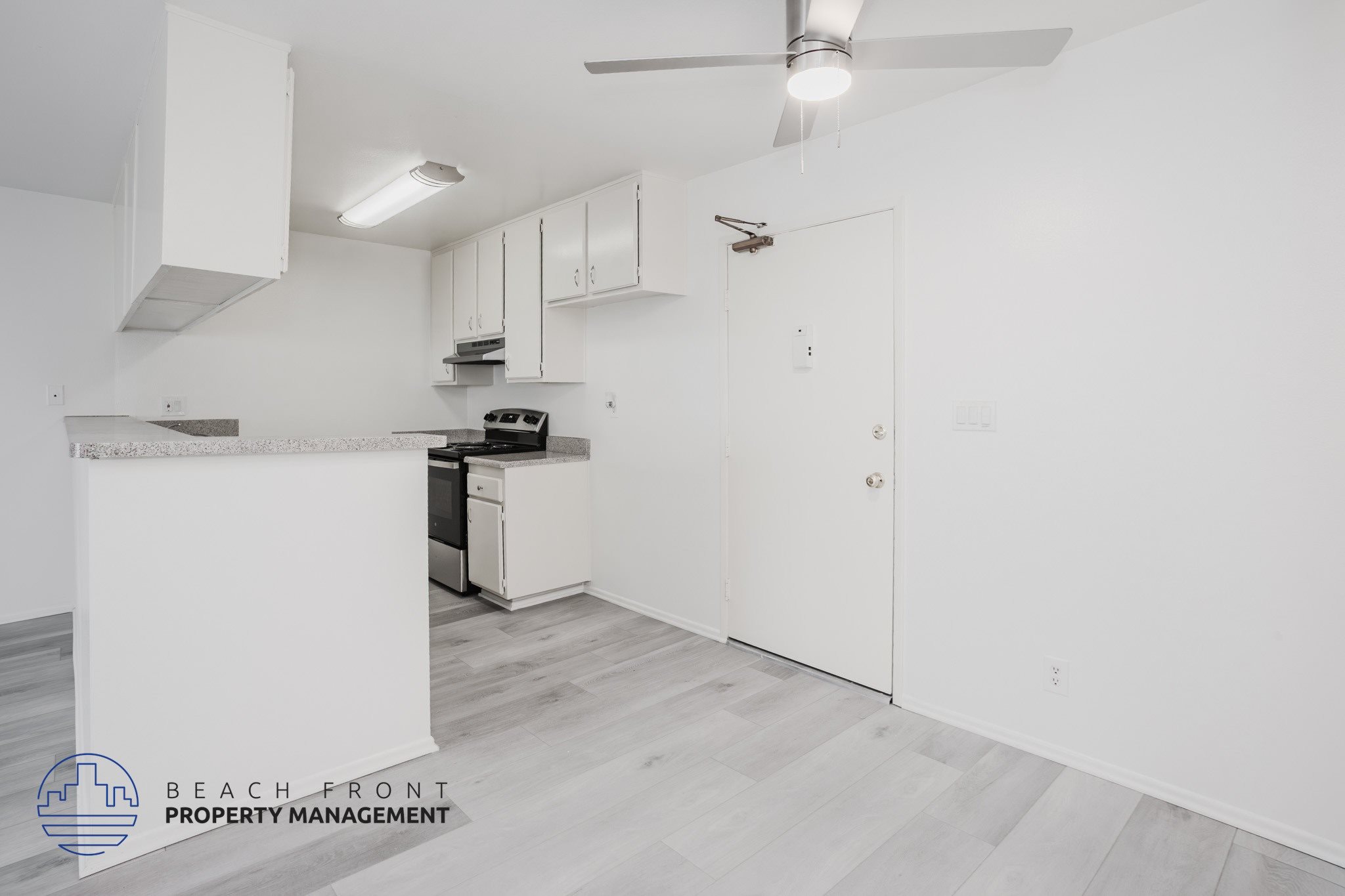 A kitchen area with a stove, oven, and cabinets.