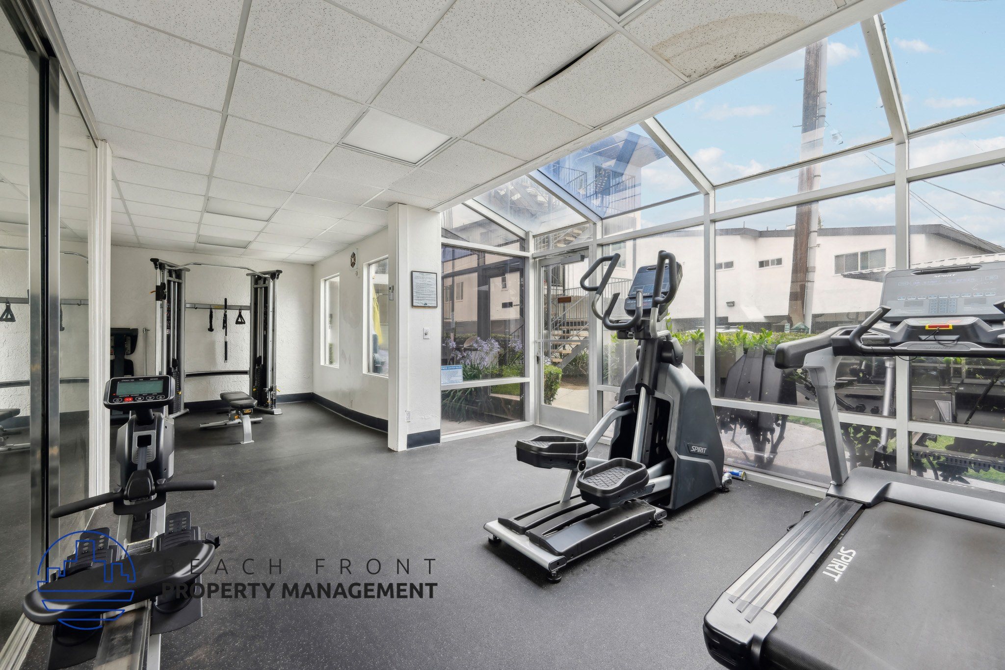A gym with treadmills, weights, and exercise equipment.