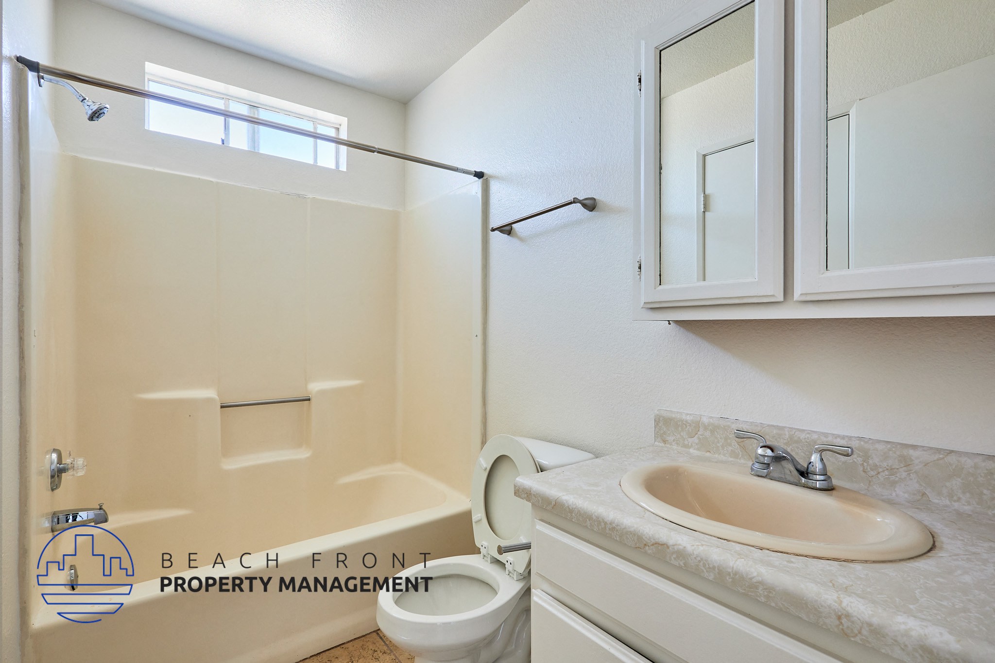 A bathroom with a sink, toilet and shower.