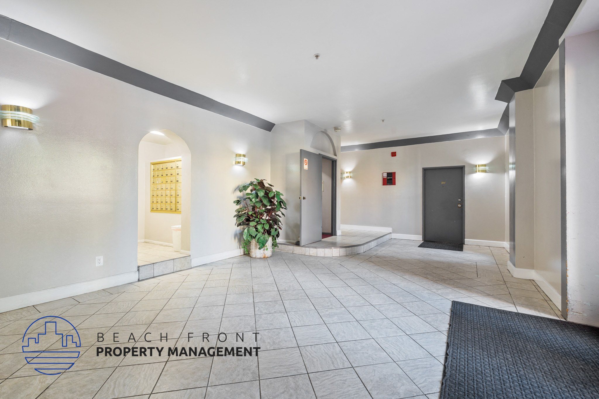 A hallway with a plant in the middle and a sign that says