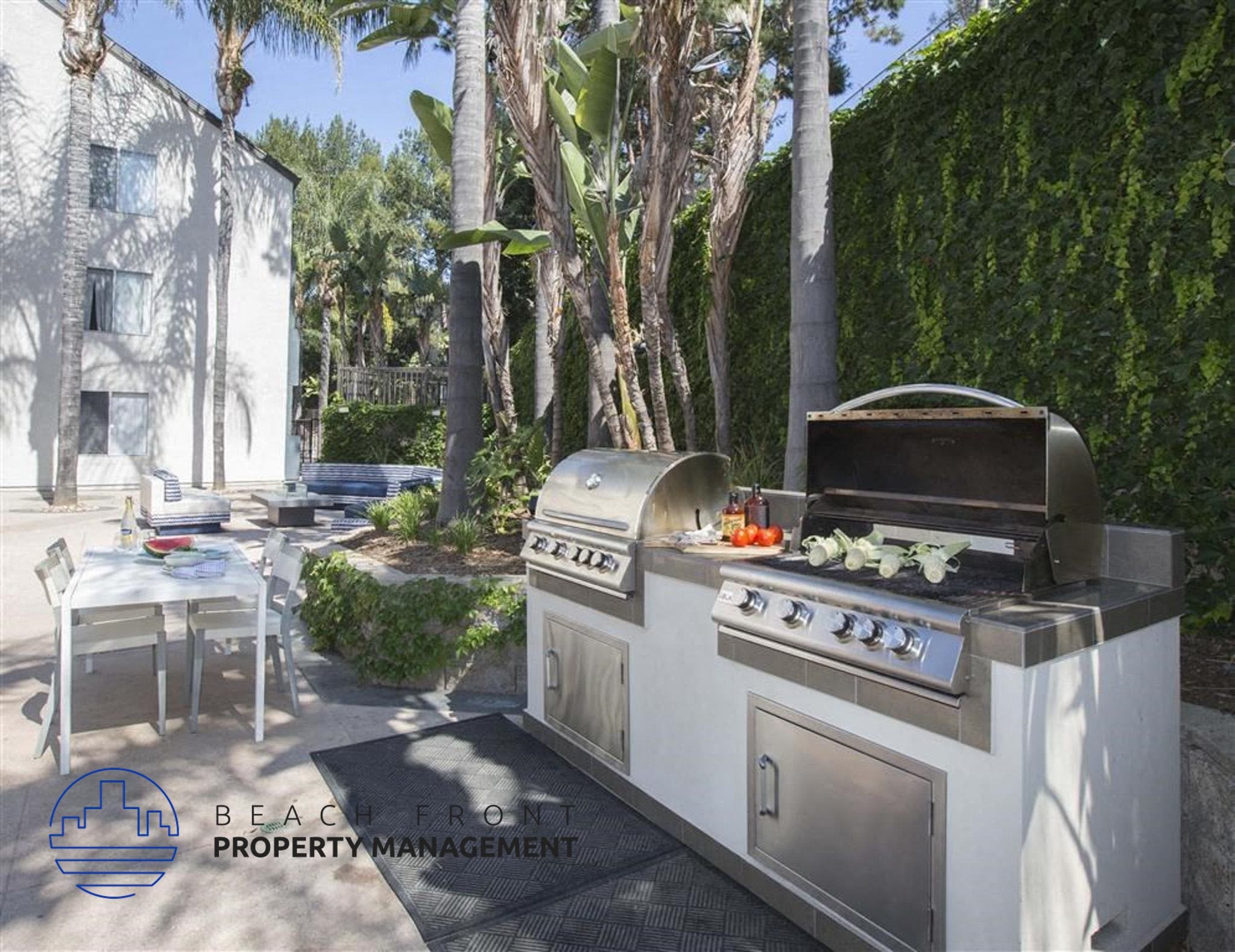 a barbecue grill in a backyard next to a table