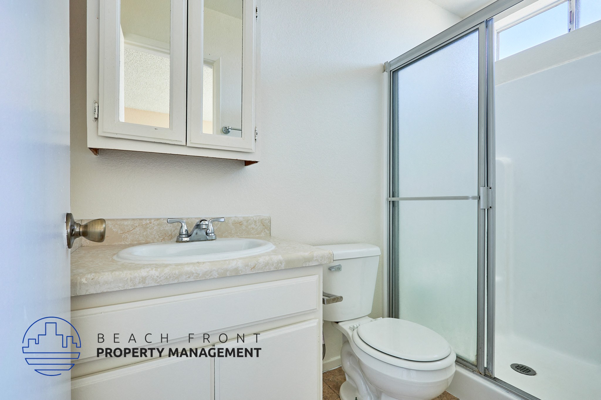 A bathroom with a sink, toilet, and shower.
