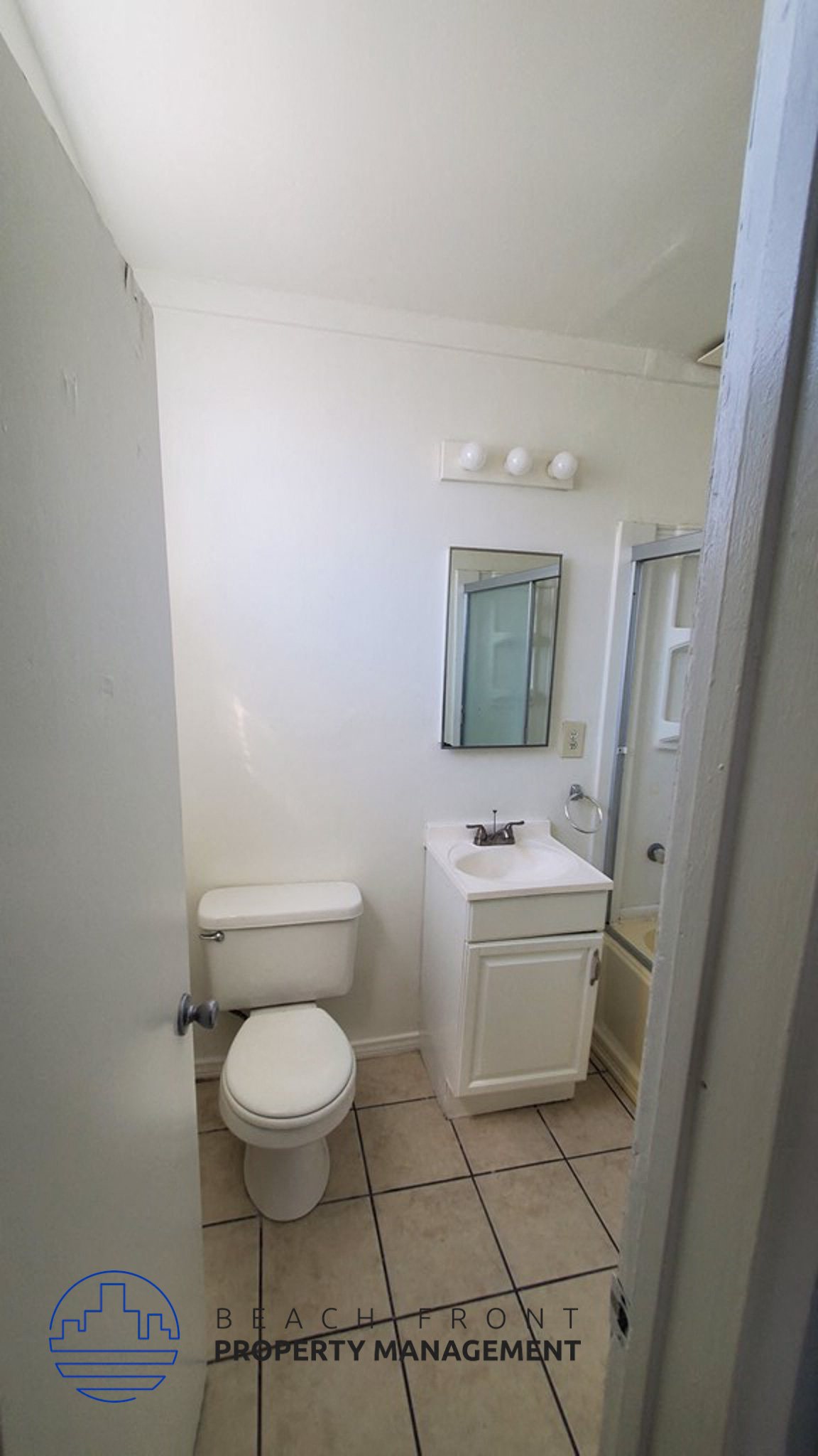 a bathroom with a toilet and a sink and a mirror