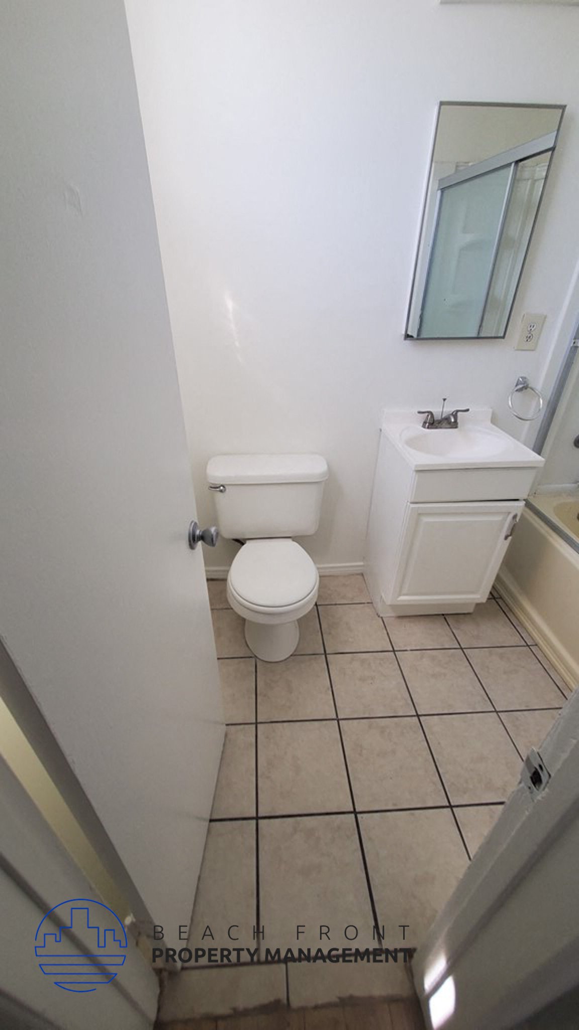 a white bathroom with a toilet and a sink
