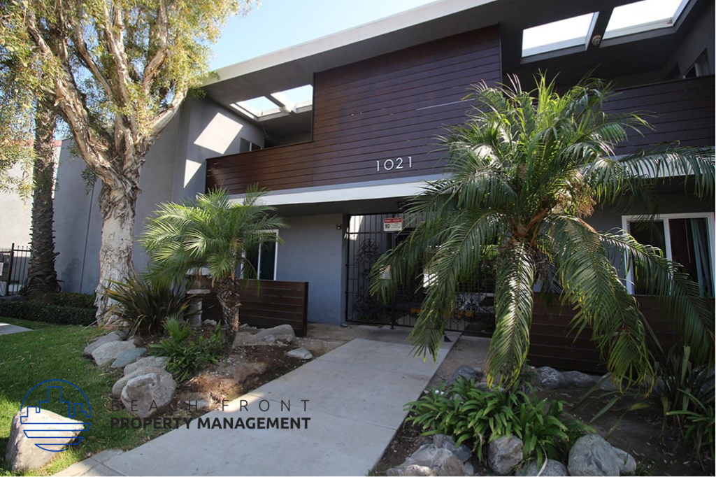 A building with the number 1021 on it is surrounded by plants and trees.
