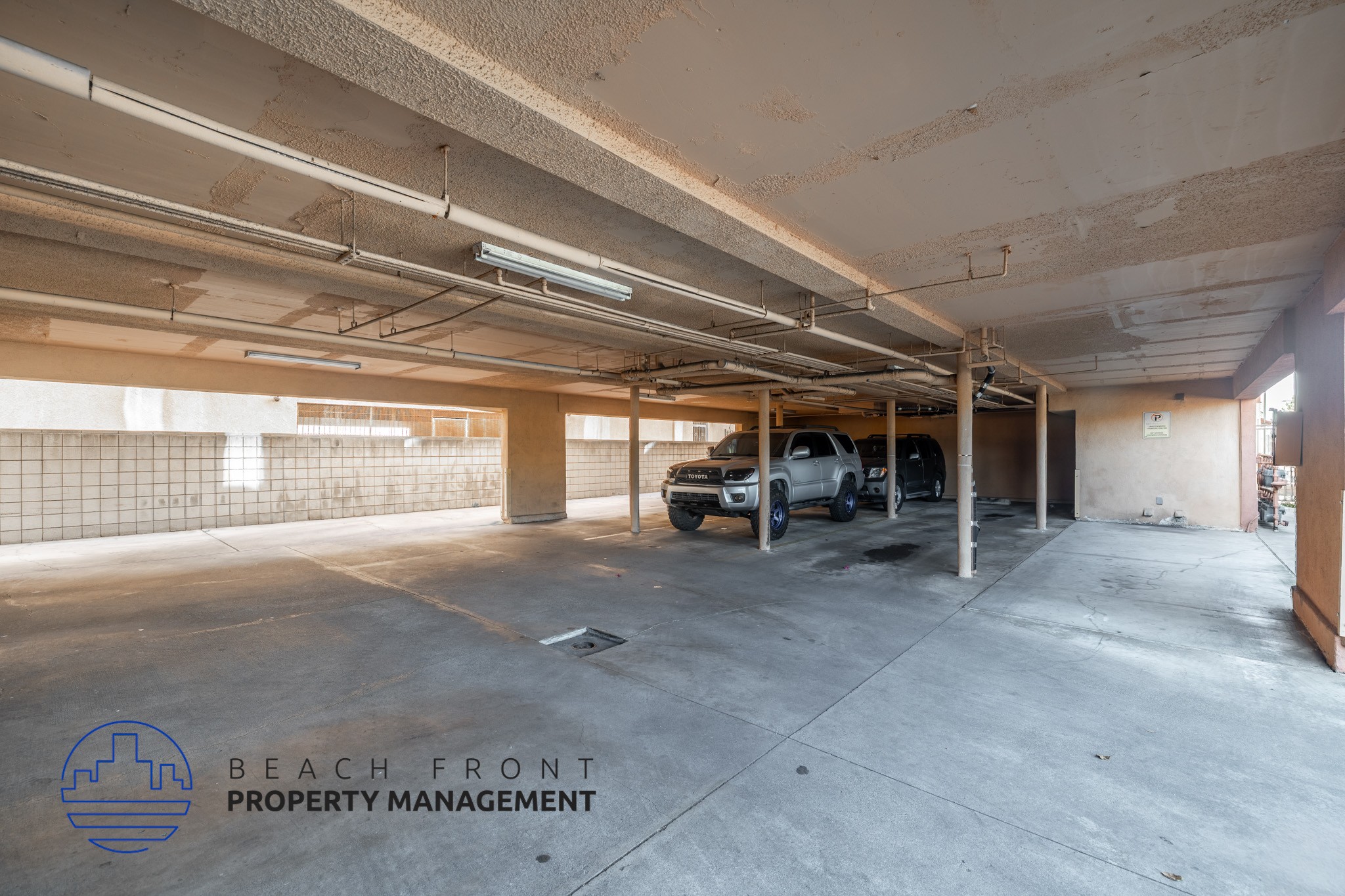 A large, empty parking garage with a car parked in the middle.