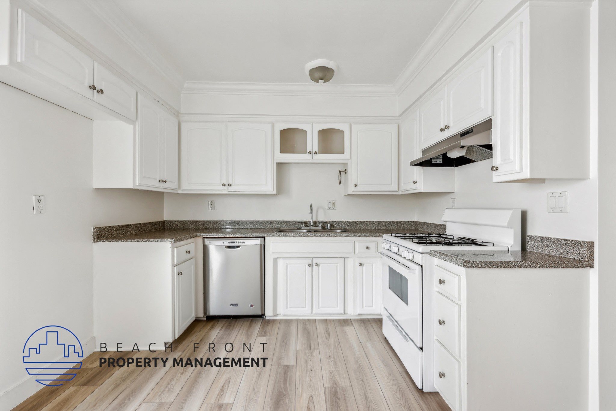 A kitchen with white cabinets and a stainless steel dishwasher.