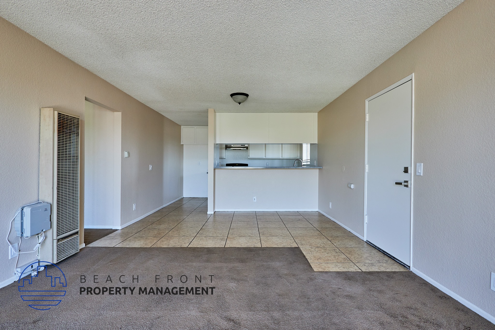 A spacious room with a carpeted floor and a white ceiling.