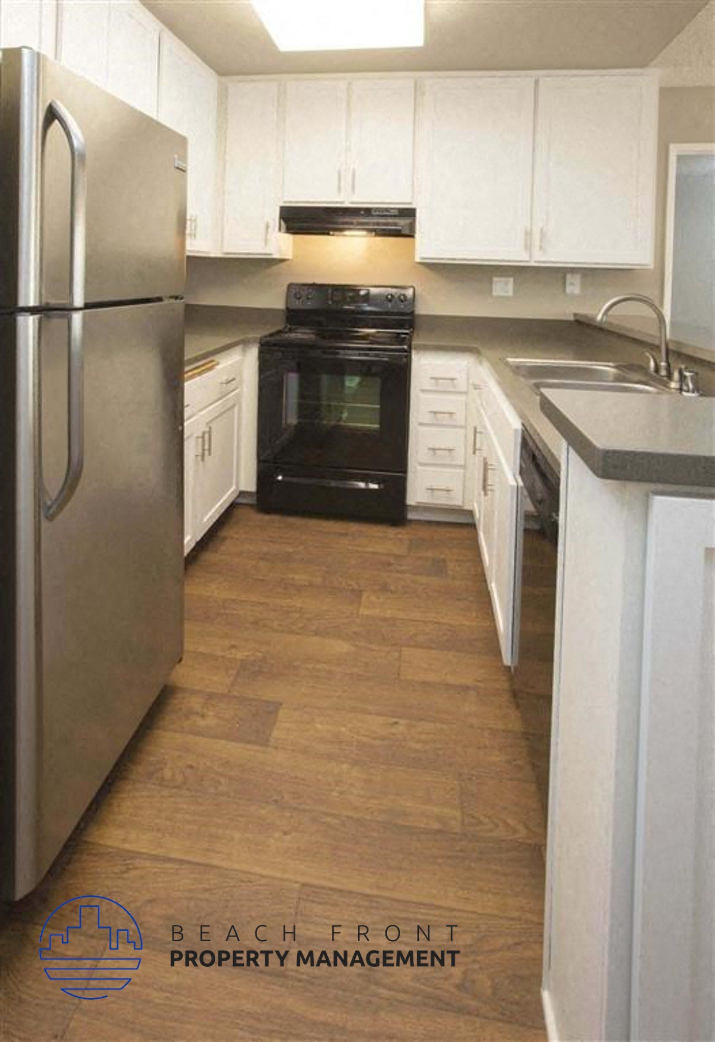 A kitchen with a refrigerator, stove, and oven.