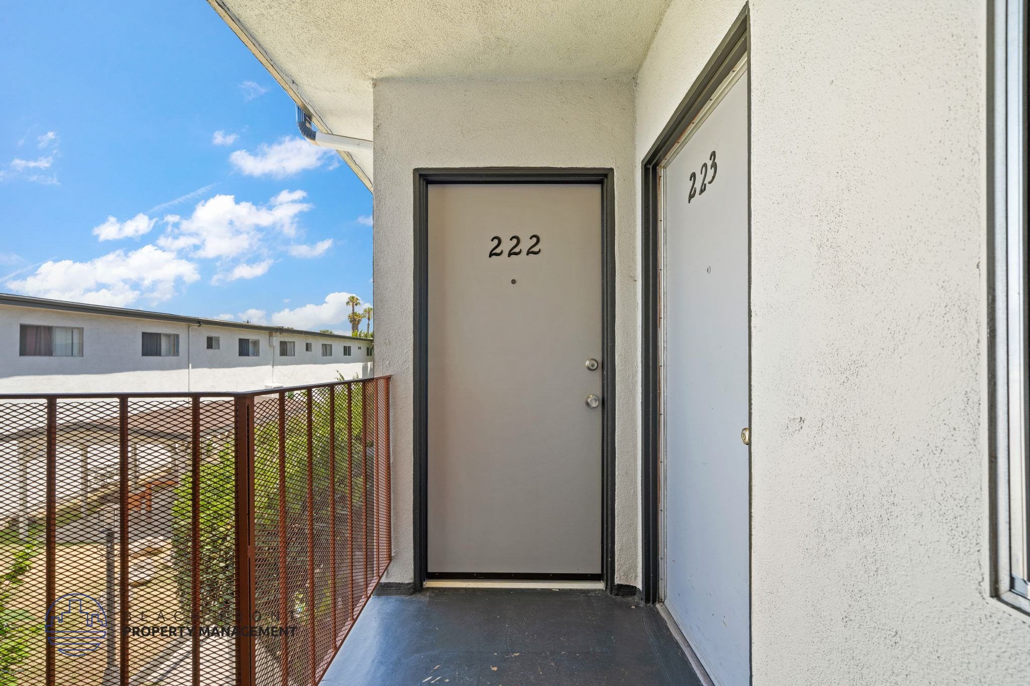 A balcony with a door numbered 222 and a window numbered 223.