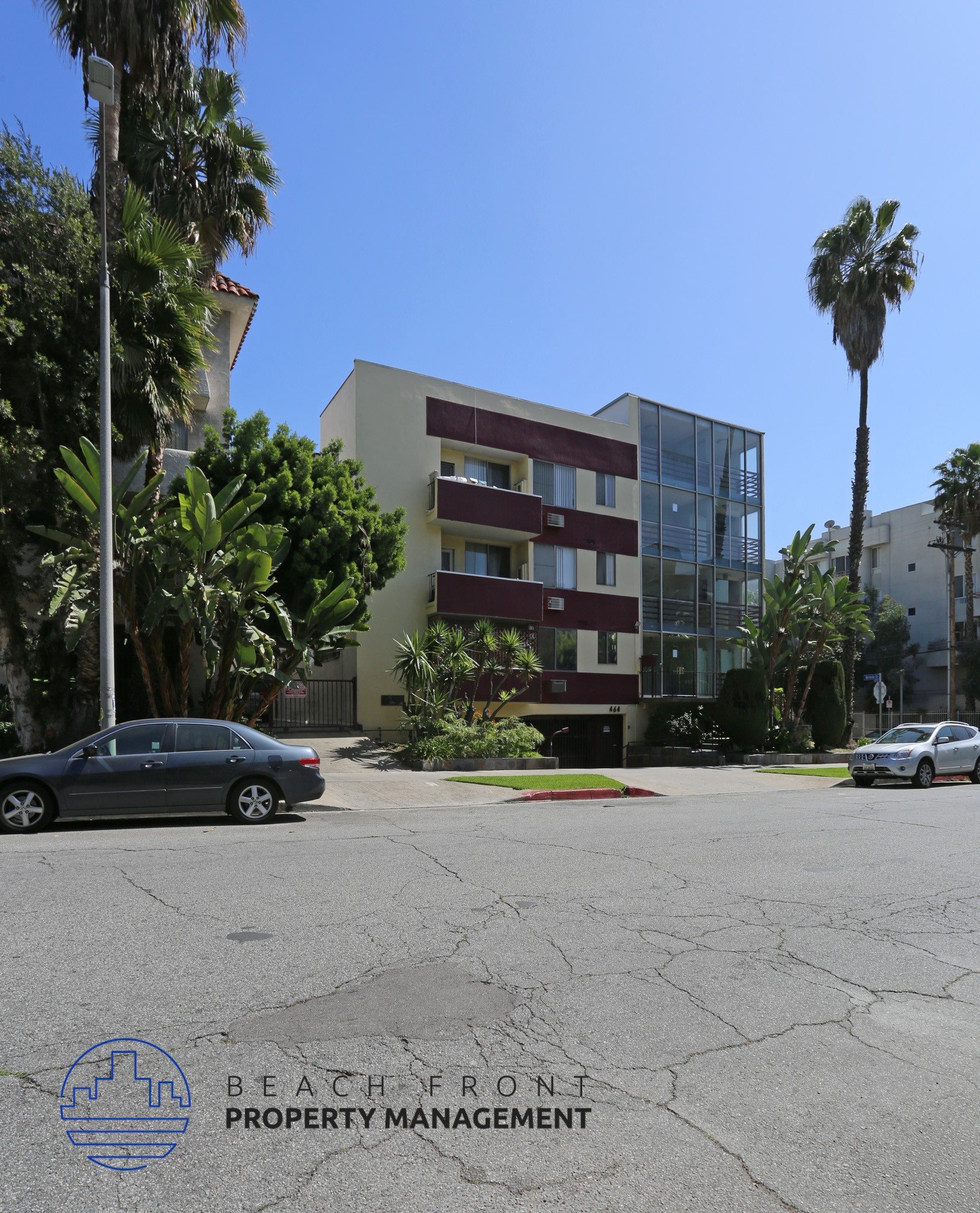 A building with the words "Beachfront Property Management" on the bottom left corner.