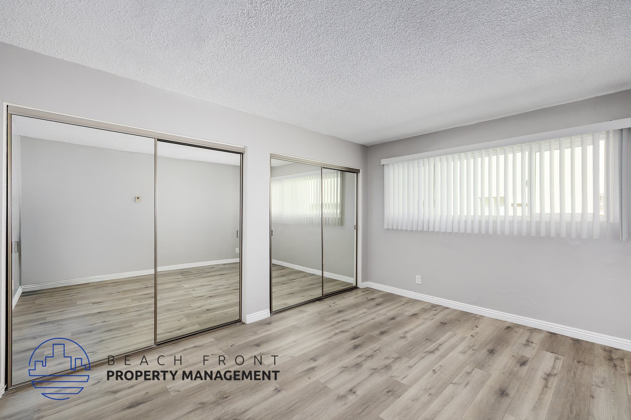 A room with a sliding door and wooden flooring.