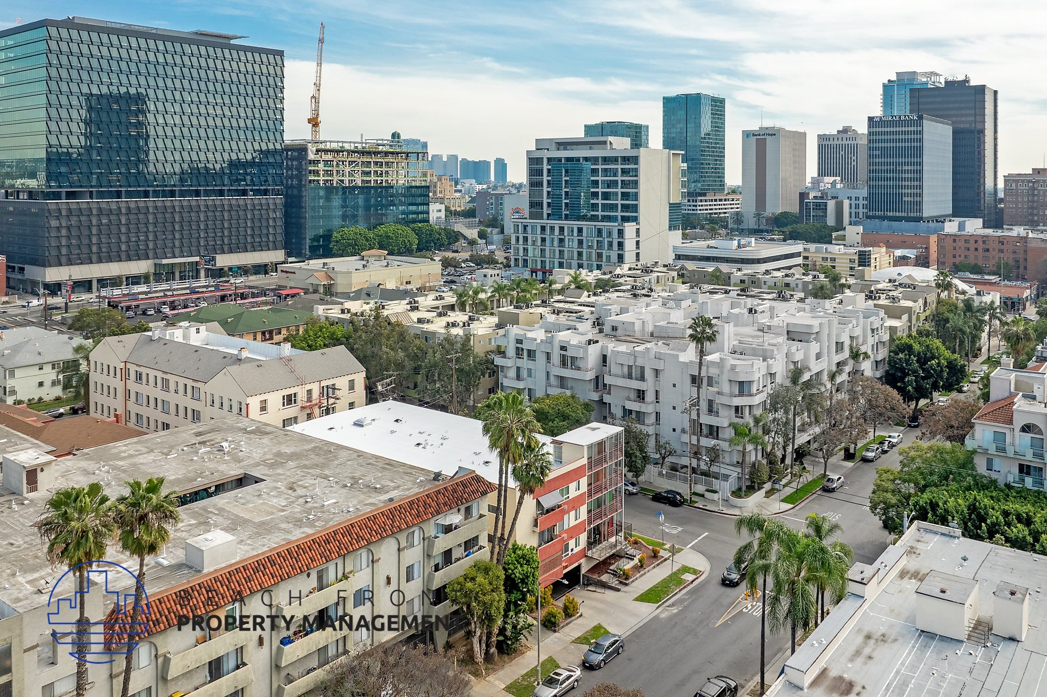 A cityscape with buildings of various heights and a clear sky.