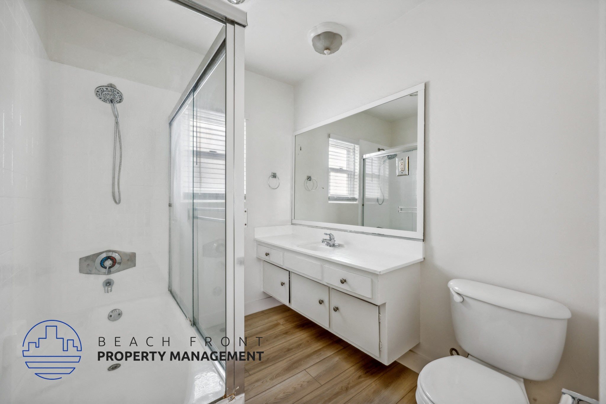 A white bathroom with a toilet, sink, and bathtub.