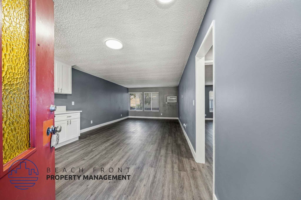 A hallway with a red door and a sign that says