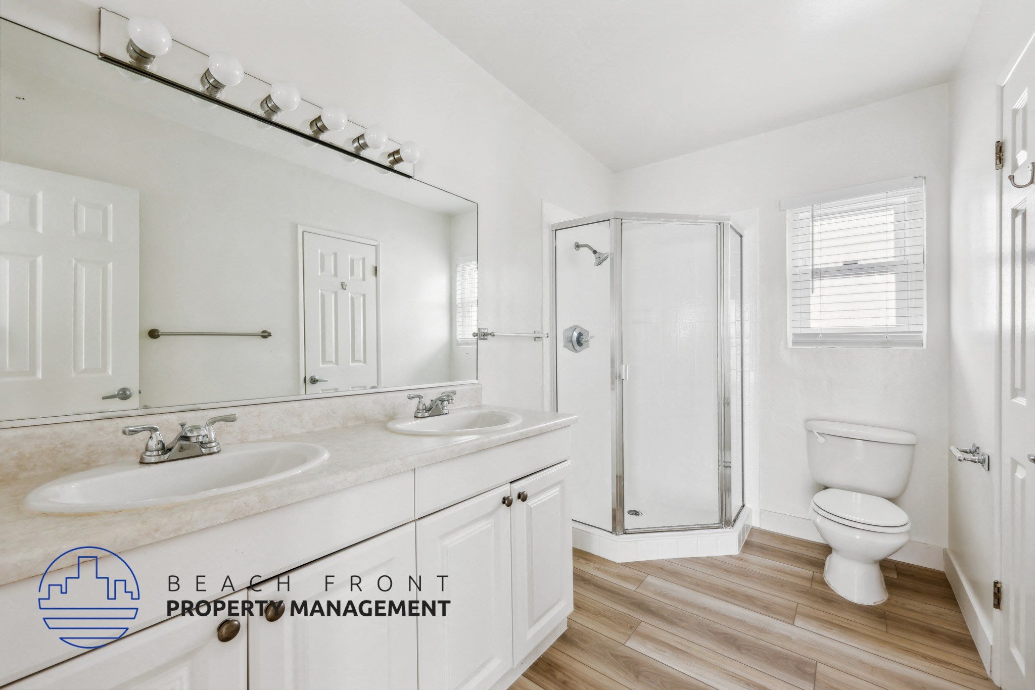 A bathroom with a white toilet, sink, and mirror.